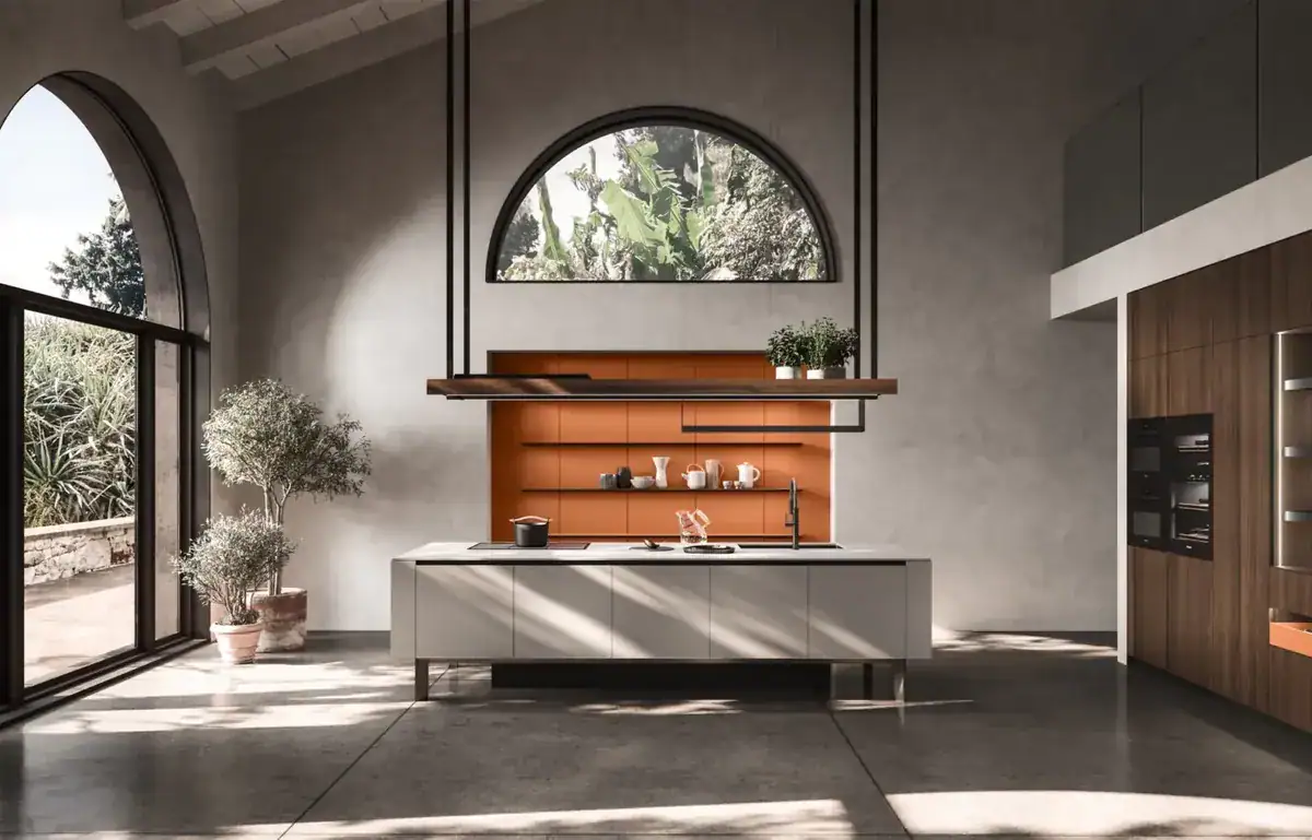Arrital kitchen with a floating island under an arched window